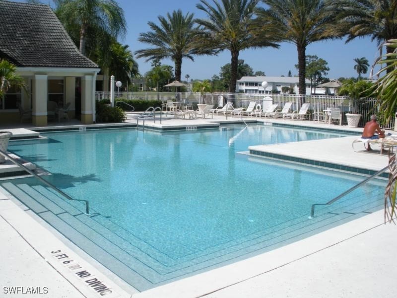 a view of a swimming pool with chairs