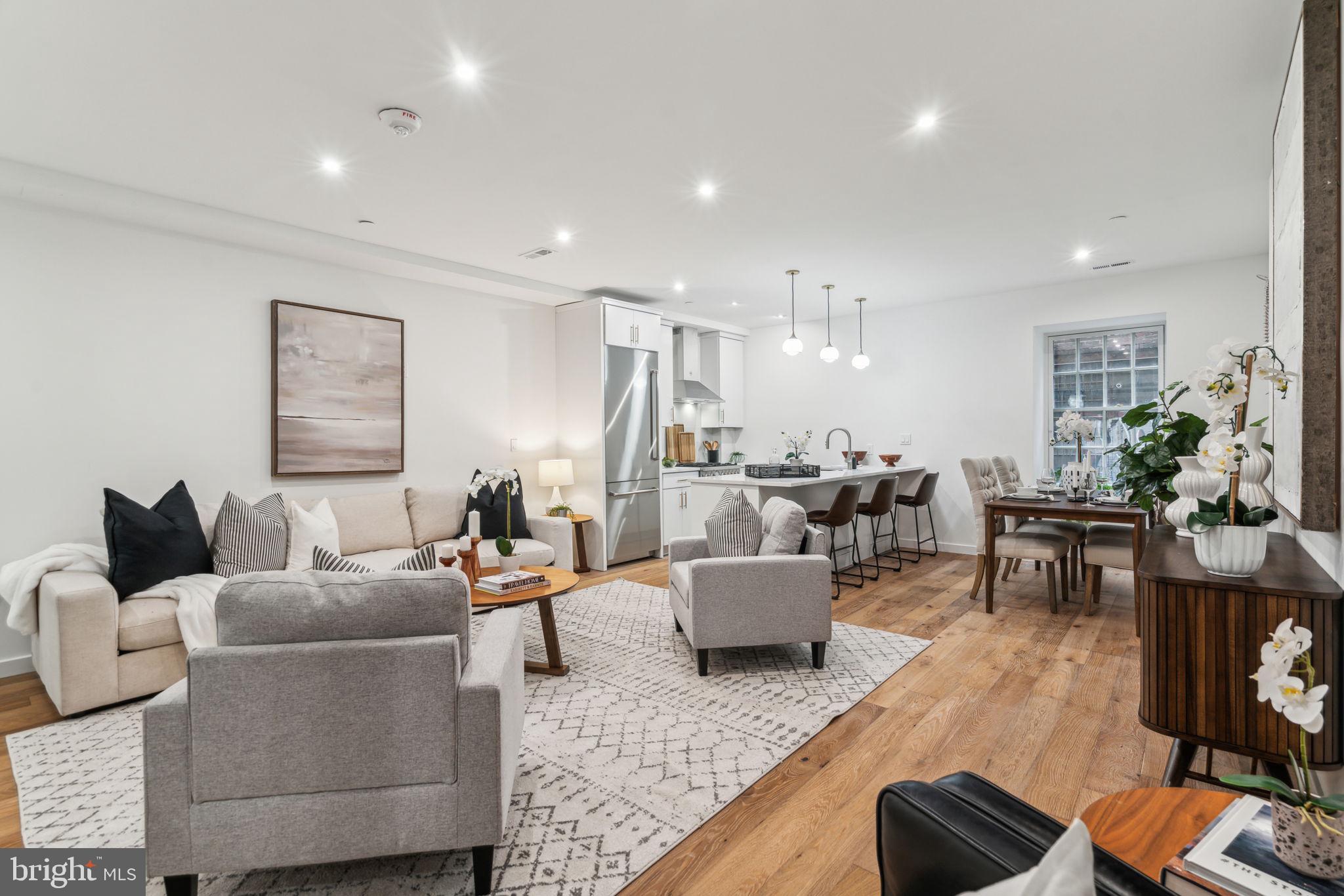 a living room with furniture kitchen view and a table