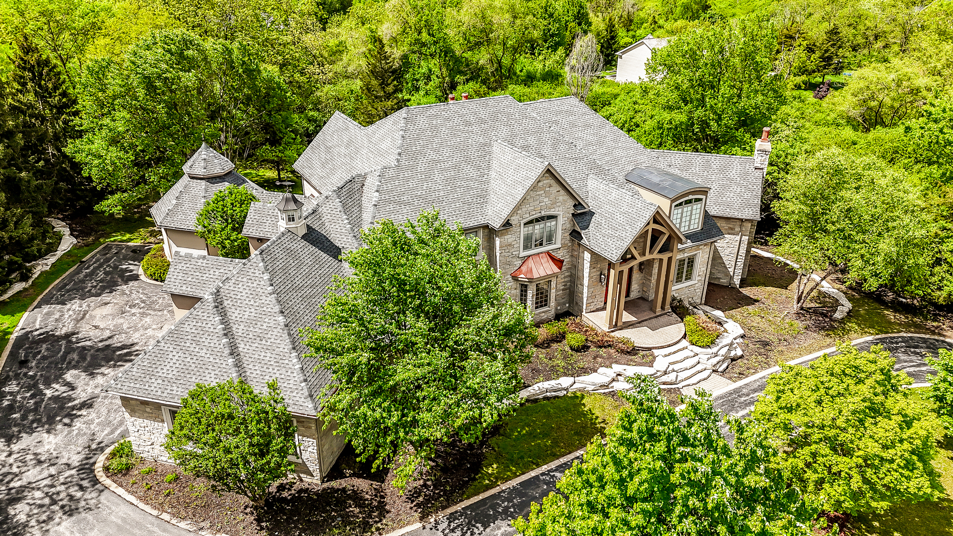 an aerial view of a house with yard swimming pool and outdoor seating