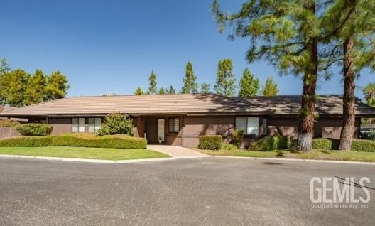 a front view of house with a garden