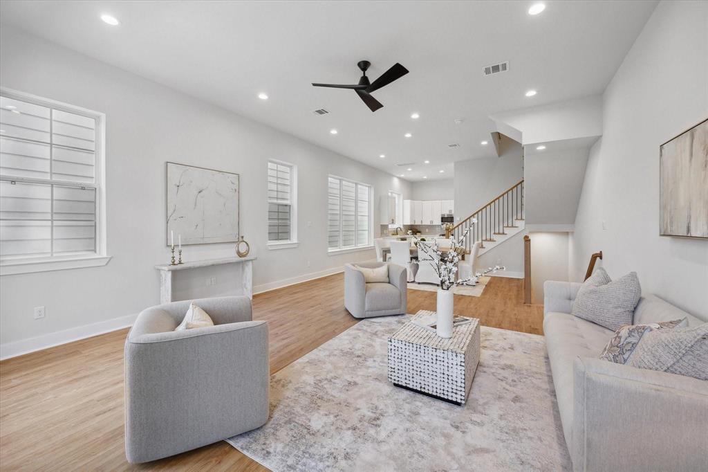 a living room with furniture and kitchen view