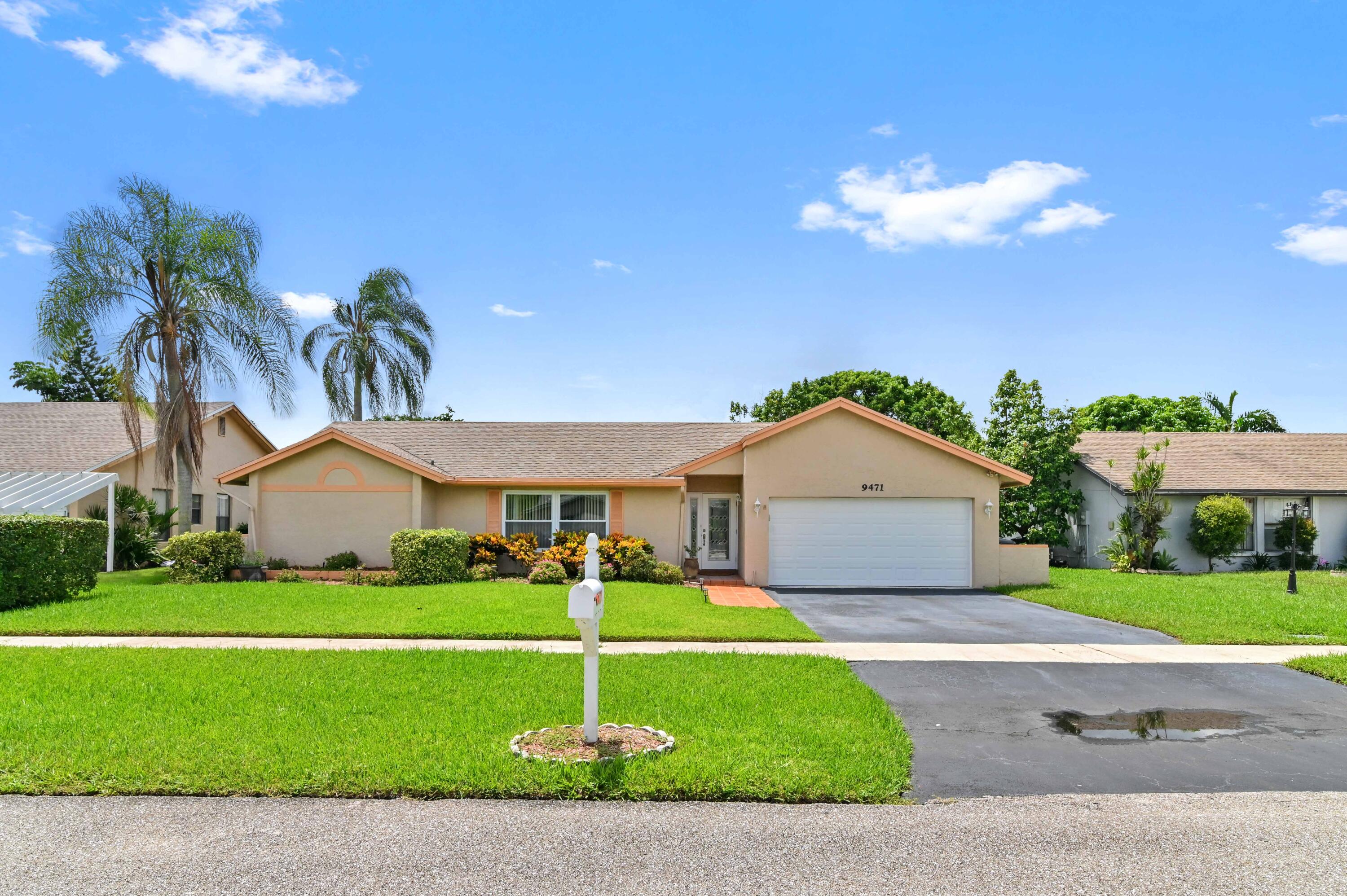 a front view of a house with a garden and yard