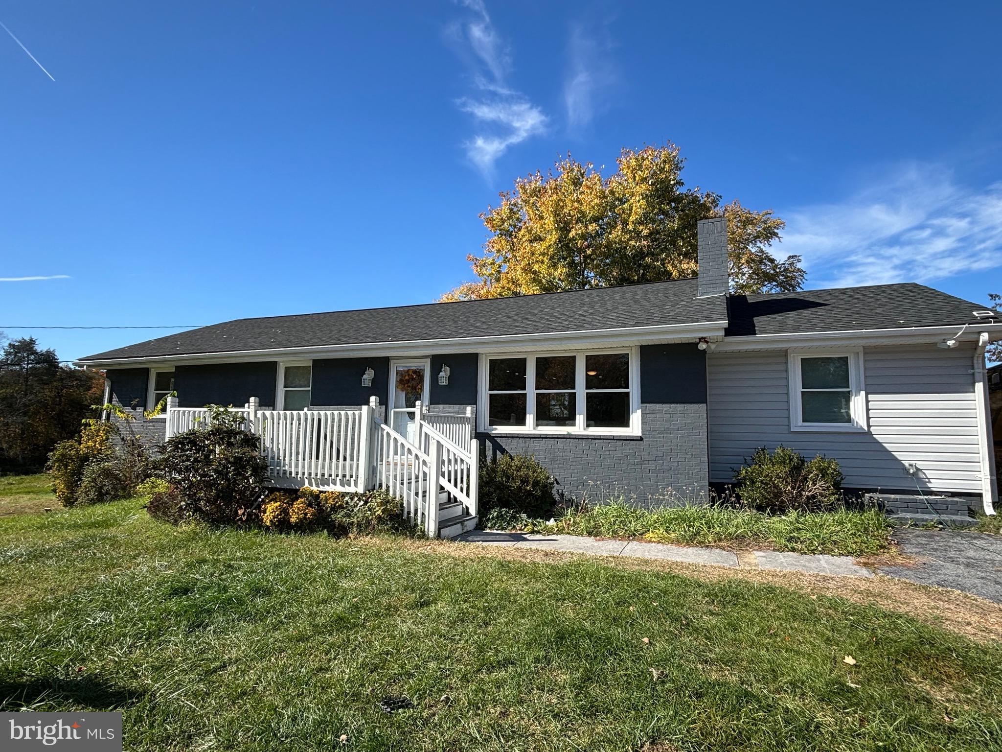 a front view of house with yard and green space