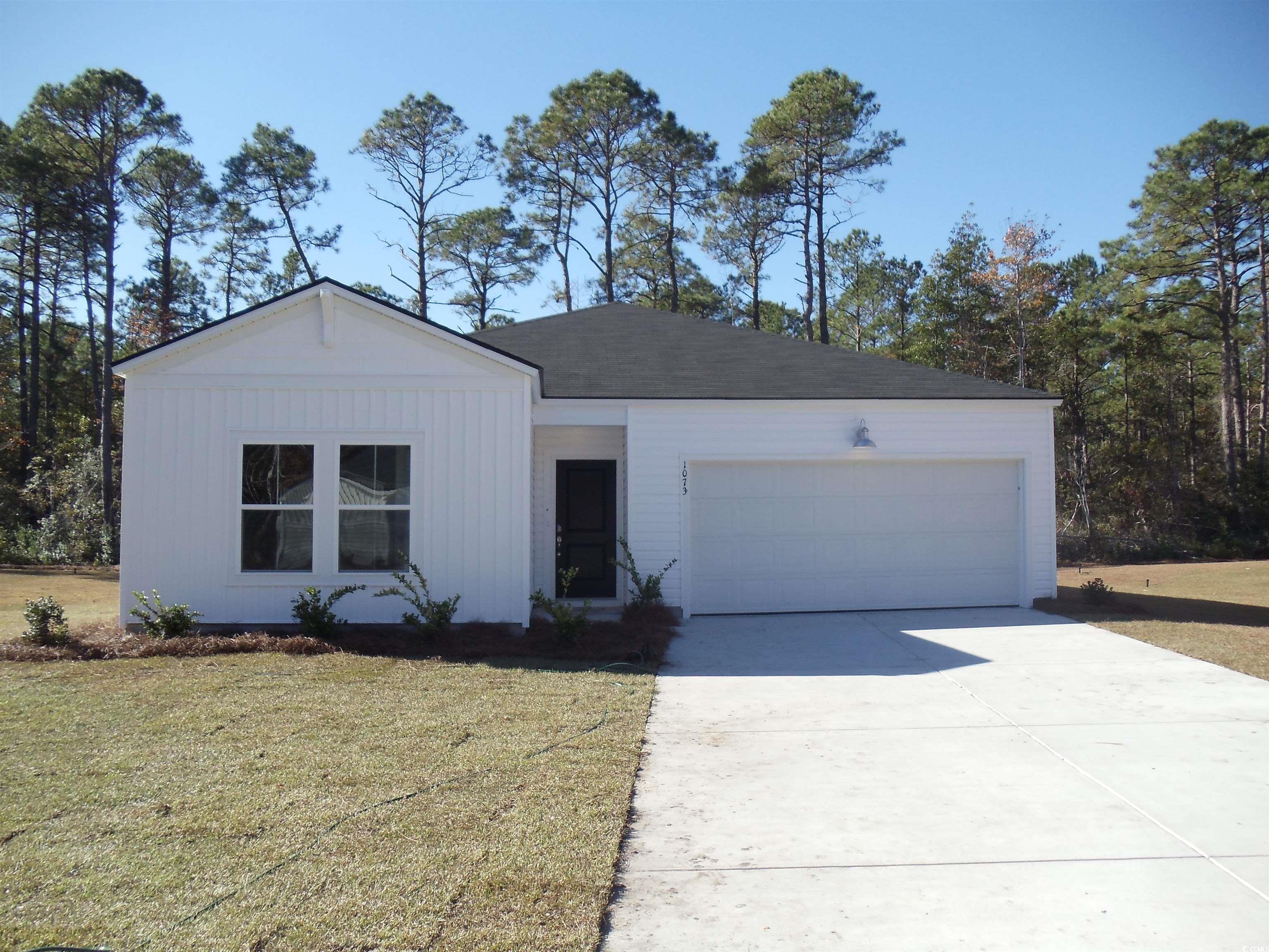 View of front of property featuring a front lawn a