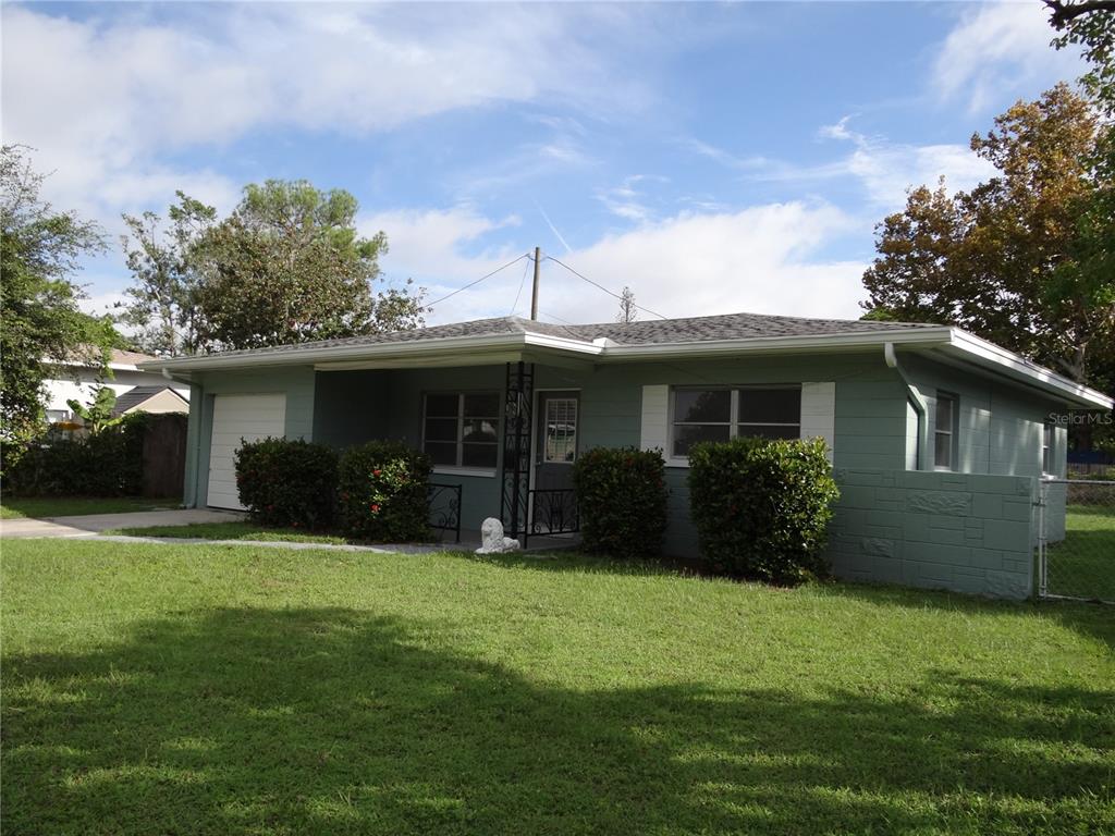 a front view of house with yard and green space