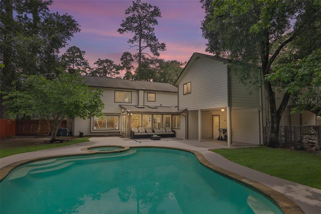 a front view of a house with a yard and trees