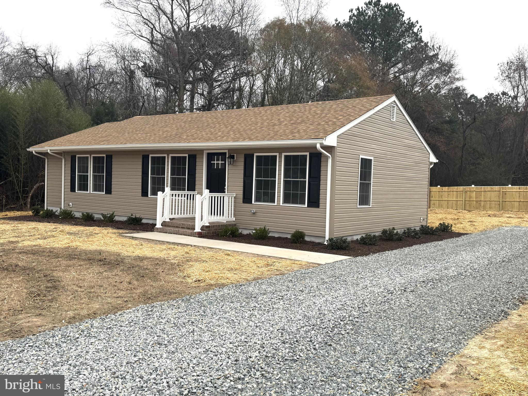 a front view of a house with yard and trees