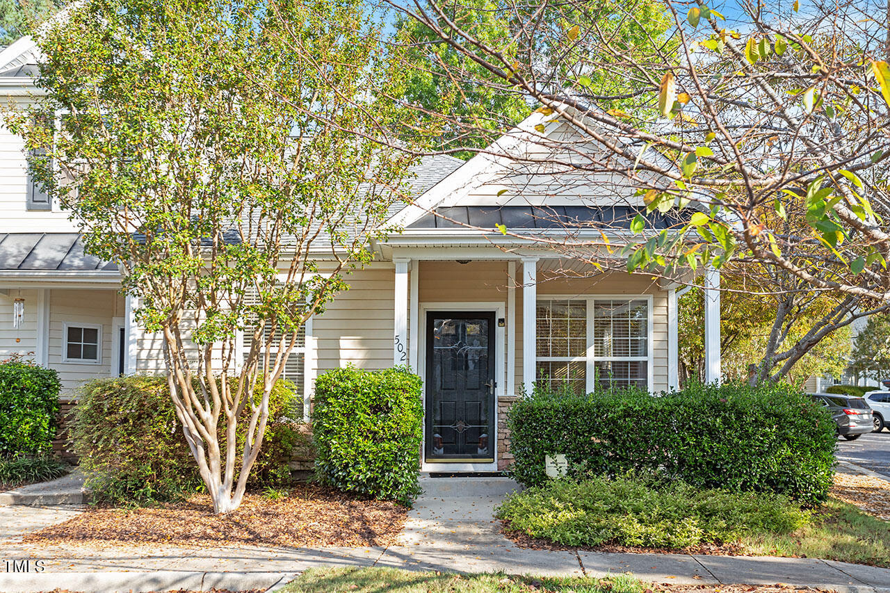 front view of a house with a tree