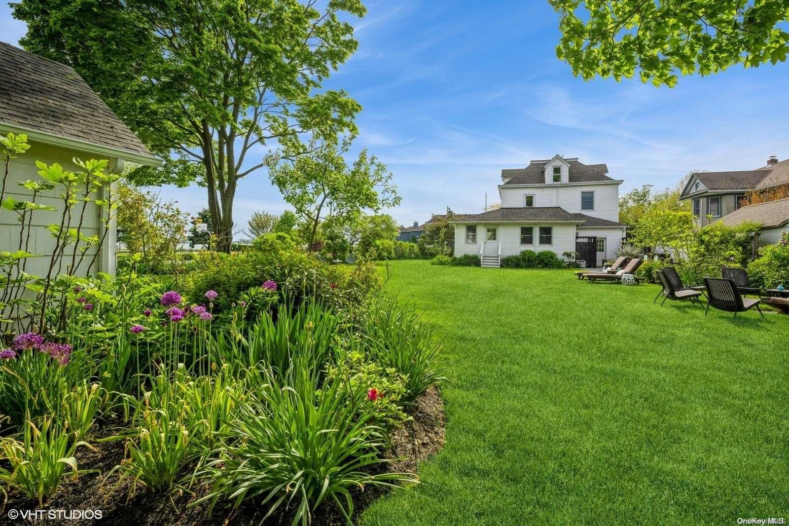 a view of a garden with a building in the background