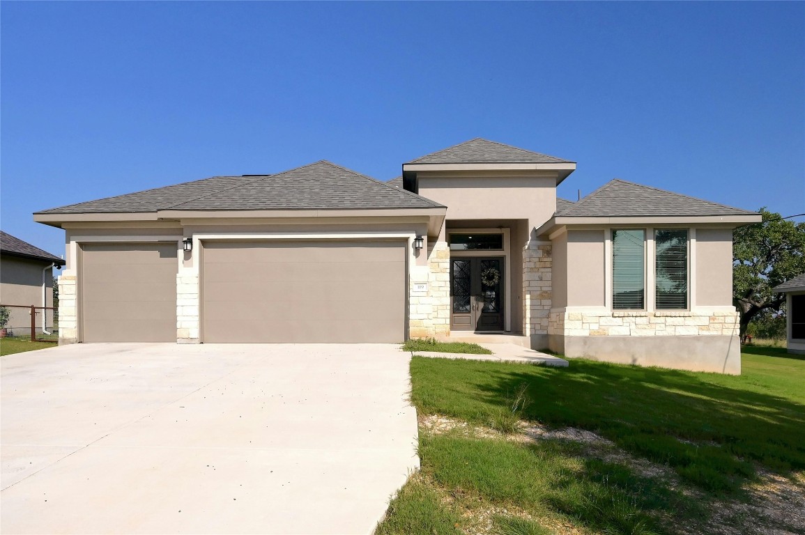 a front view of a house with a yard and garage