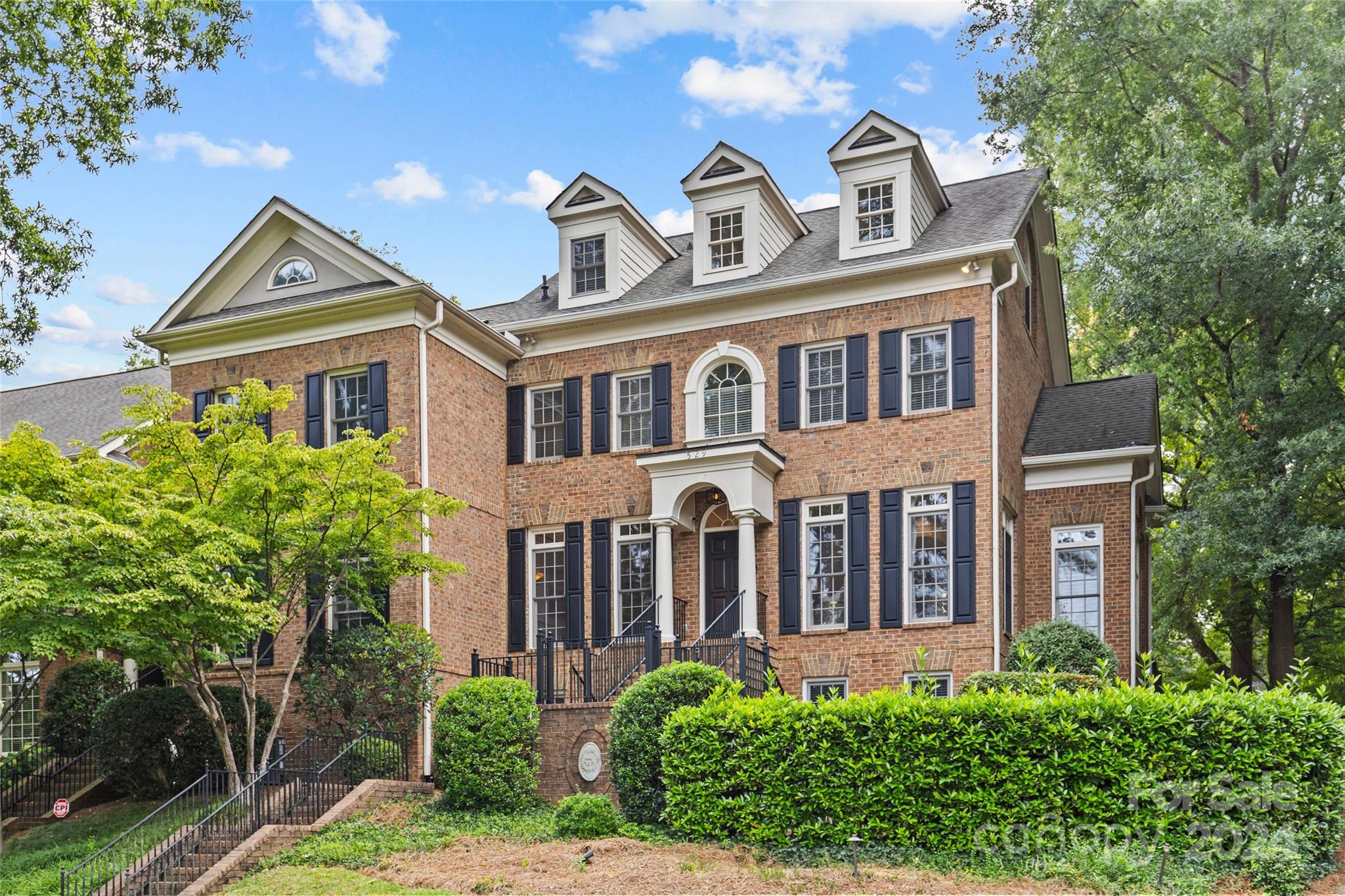 a front view of a house with garden