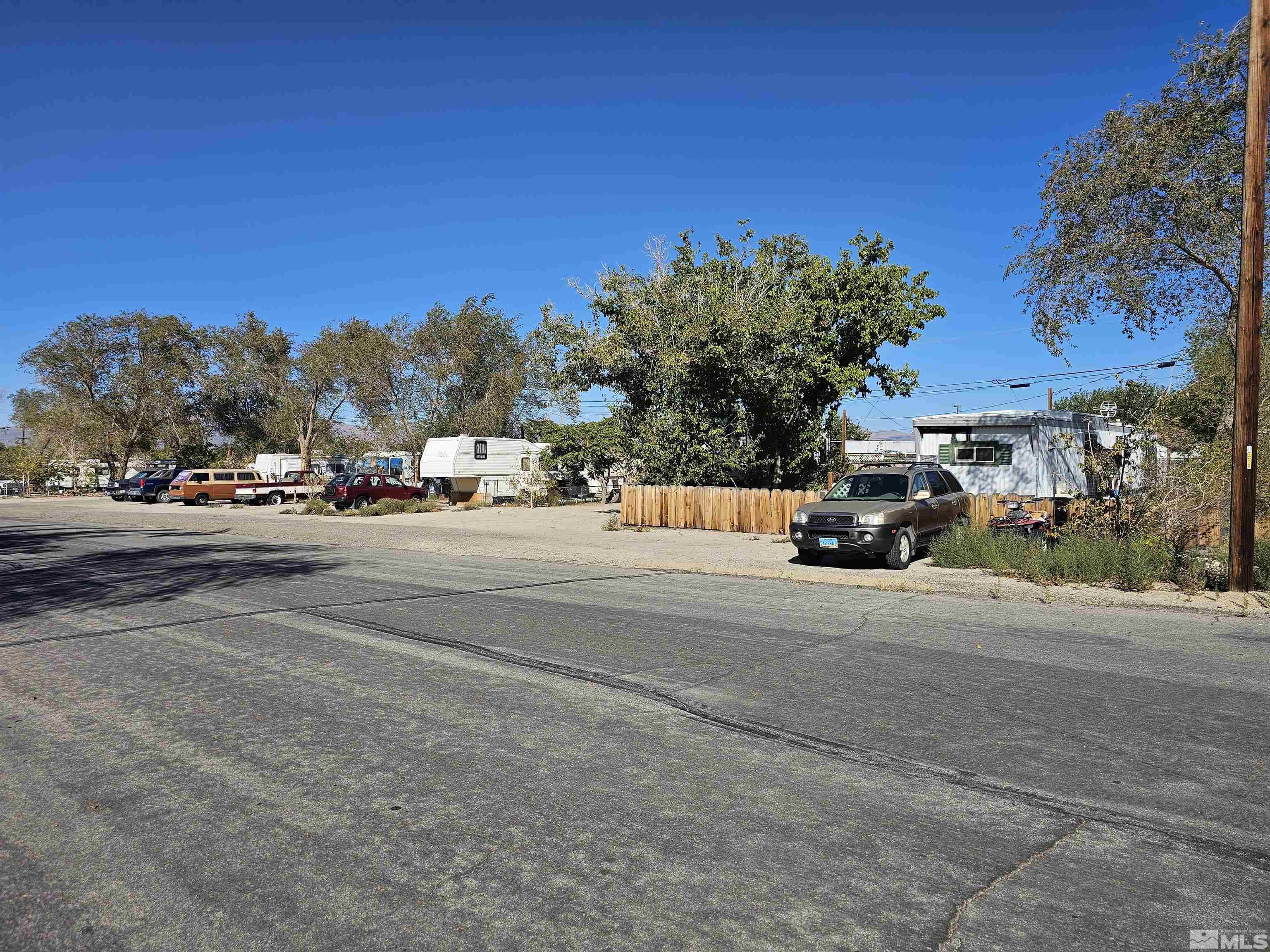 a view of street with parked cars