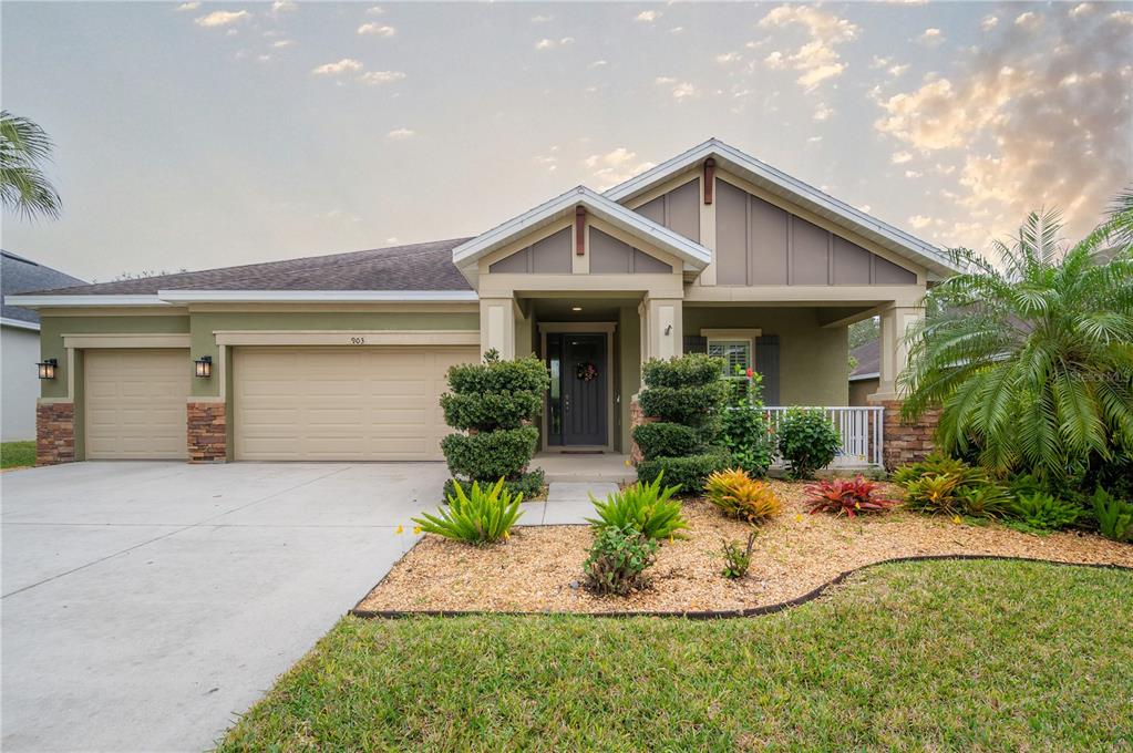 a front view of house with yard and green space