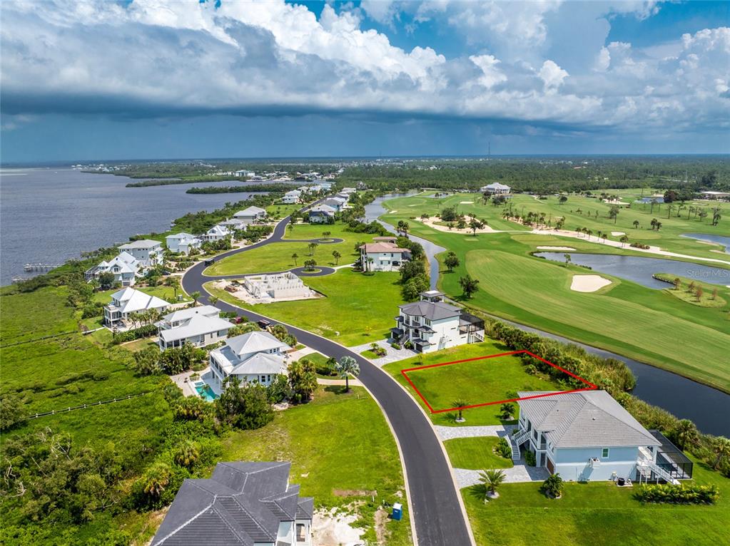 an aerial view of a houses with a yard