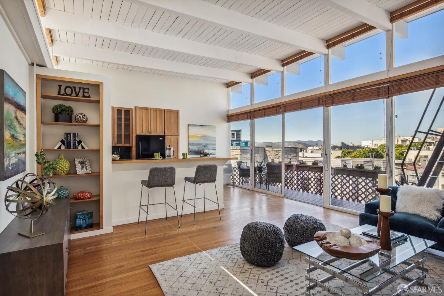 a living room with furniture a rug and a floor to ceiling window