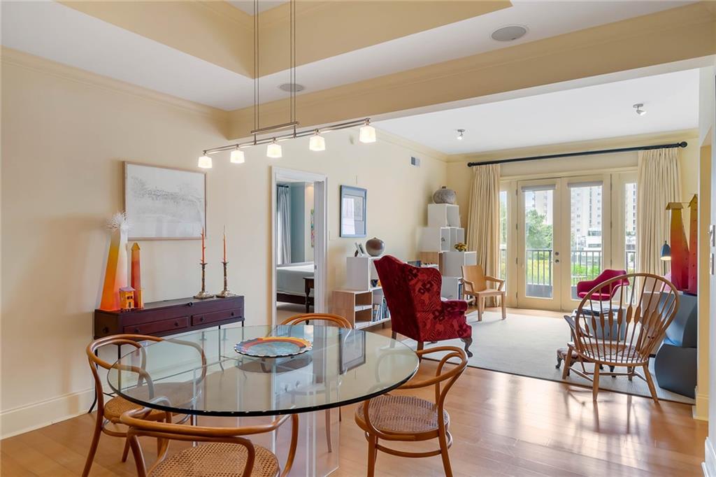 a dining room with furniture a chandelier and wooden floor