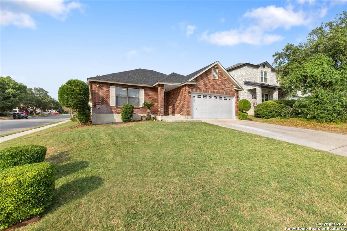 a front view of a house with a yard and garage