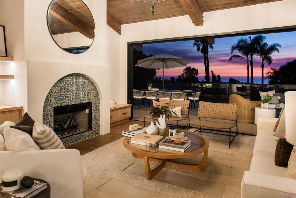 a living room with patio fireplace furniture and a fireplace