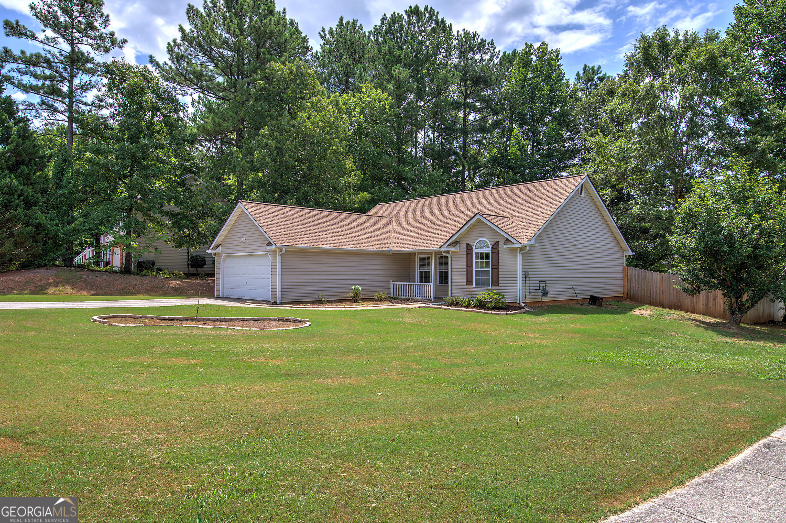 a aerial view of a house next to a big yard