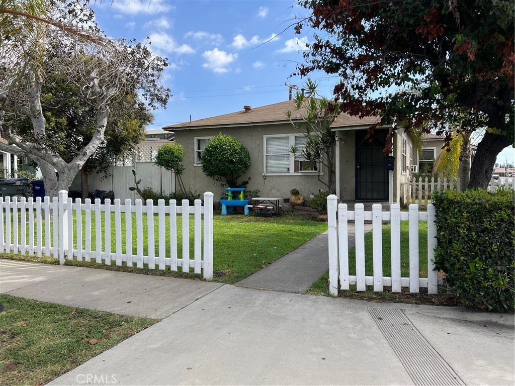 a front view of a house with a garden and plants