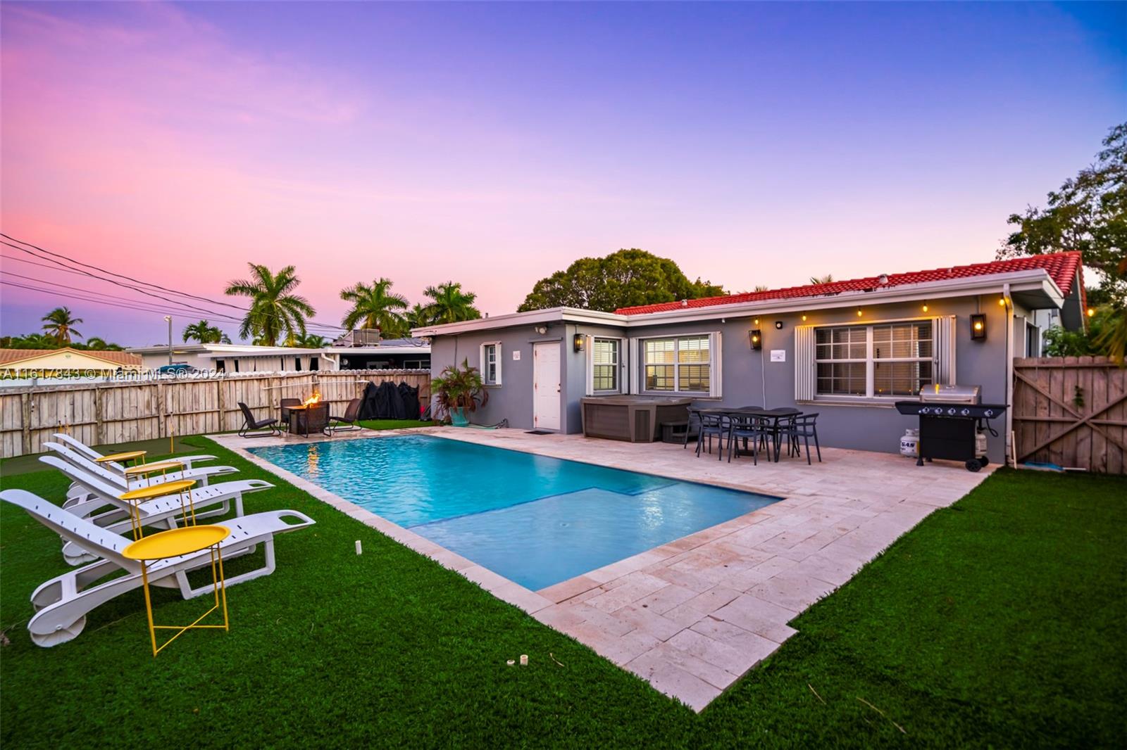 a view of a house with pool and chairs