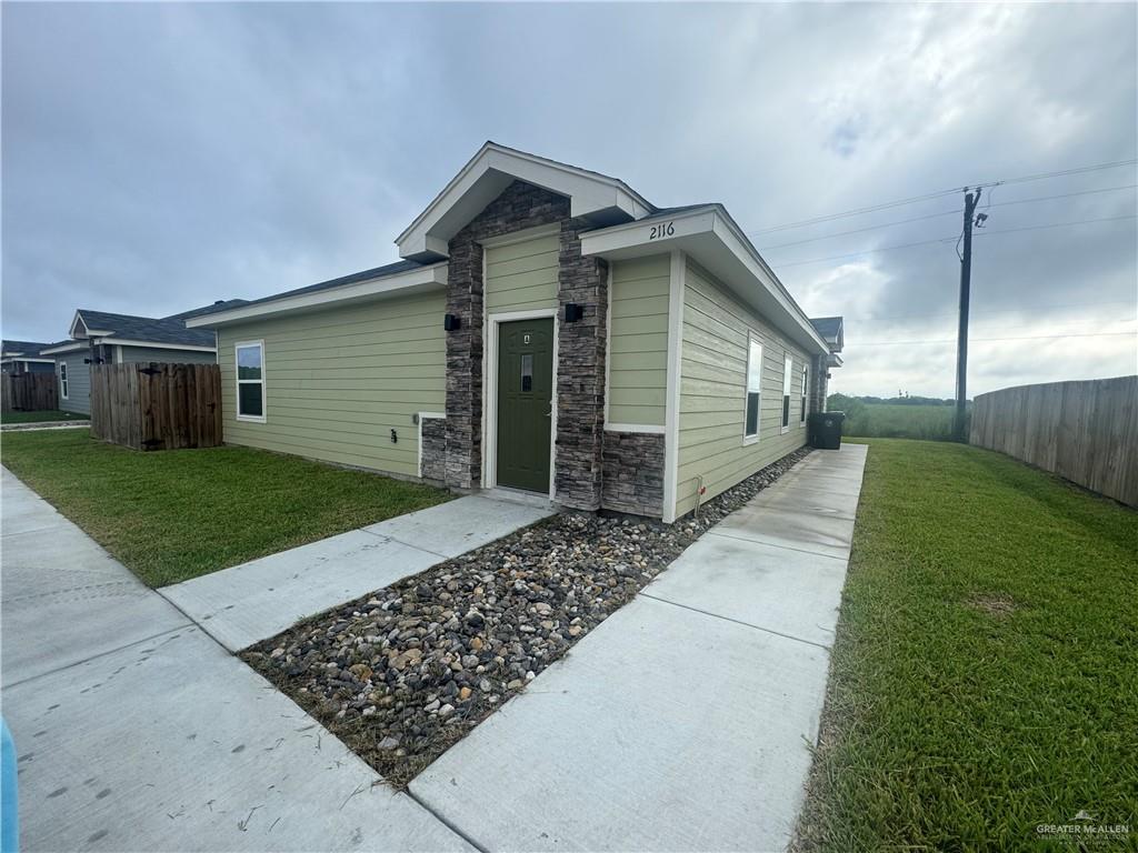 a view of a house with a yard