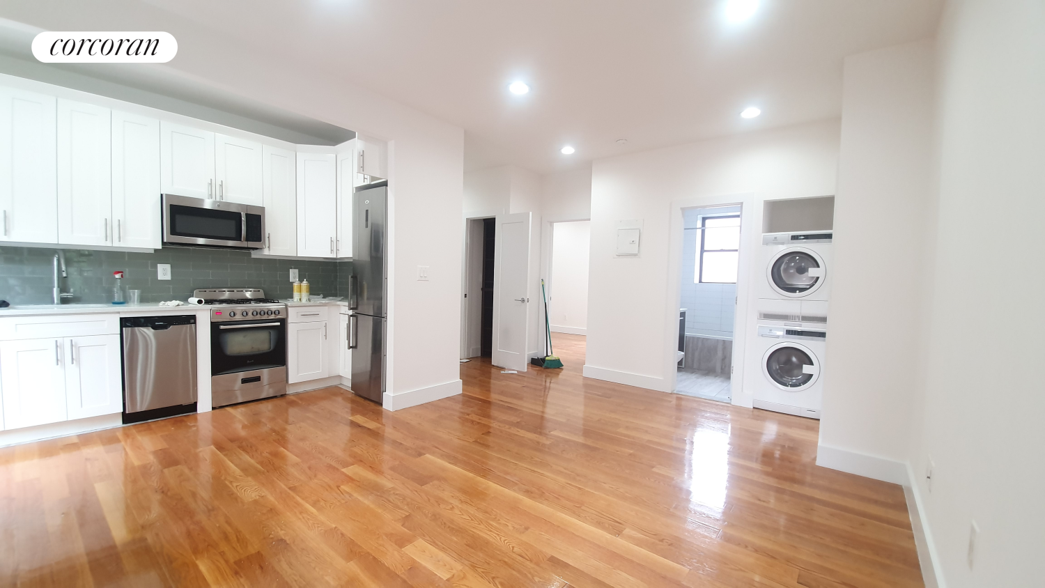 a large kitchen with stainless steel appliances granite countertop a stove and a sink