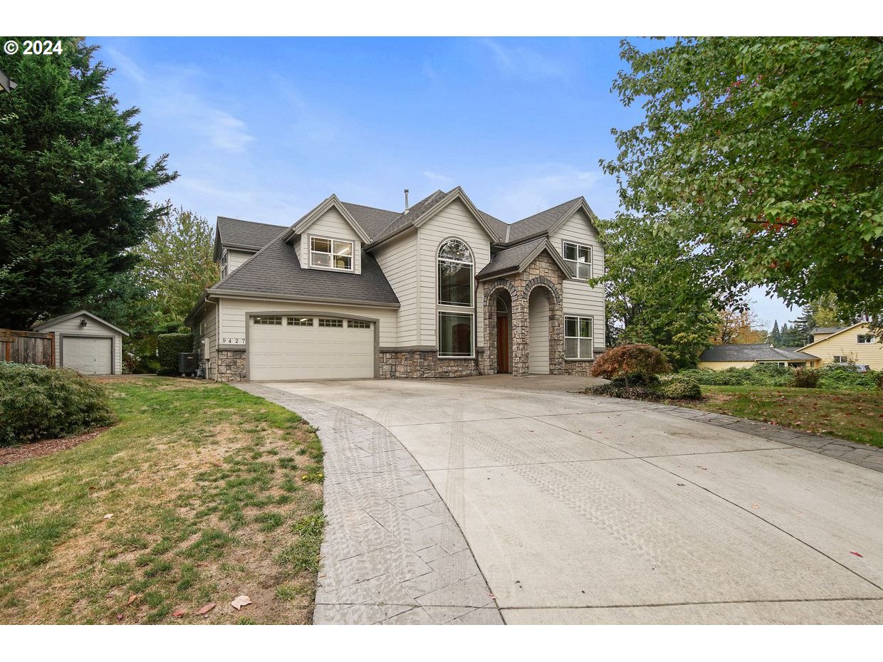 a front view of a house with a yard and garage