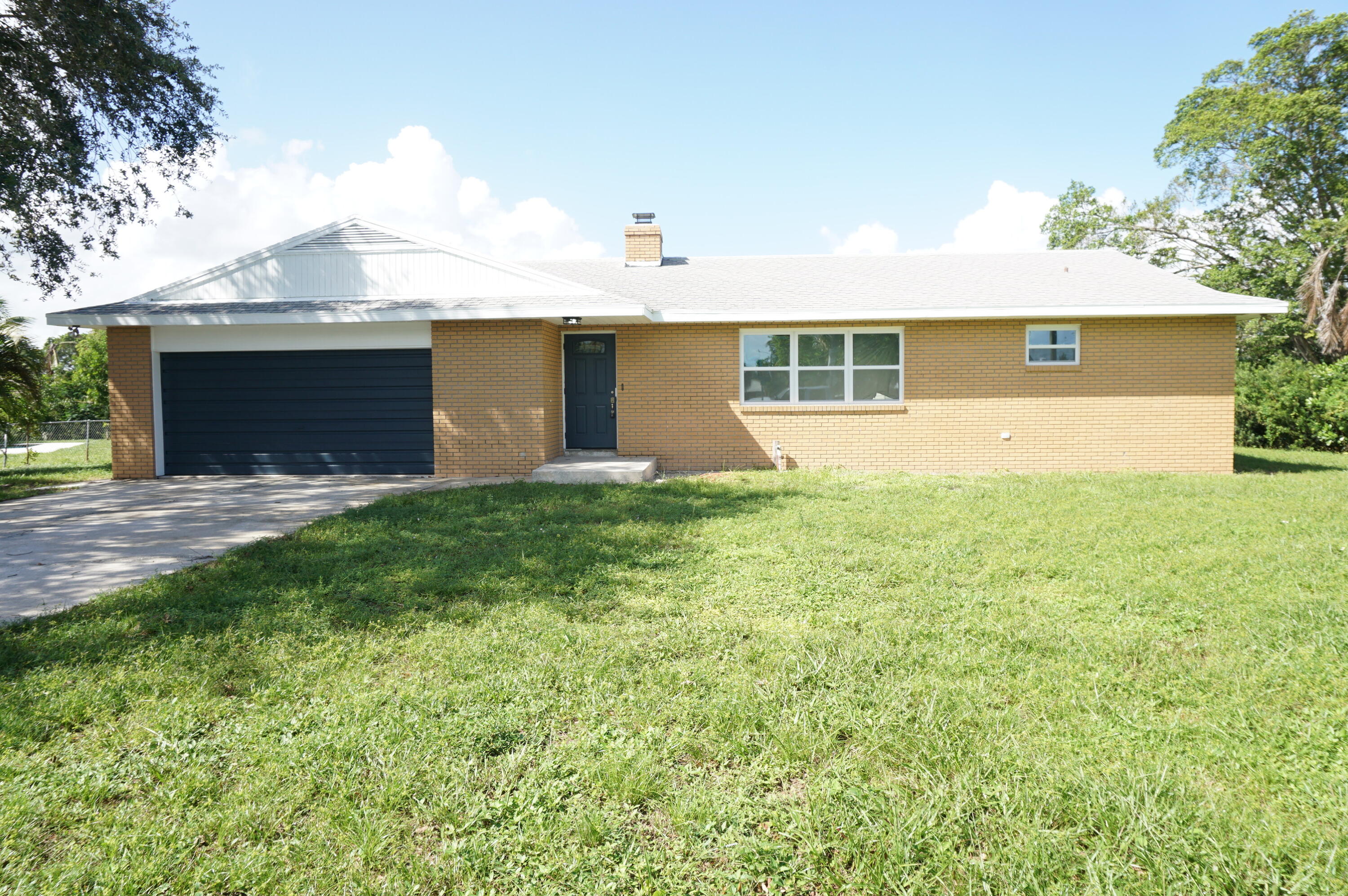 a front view of a house with yard and garage