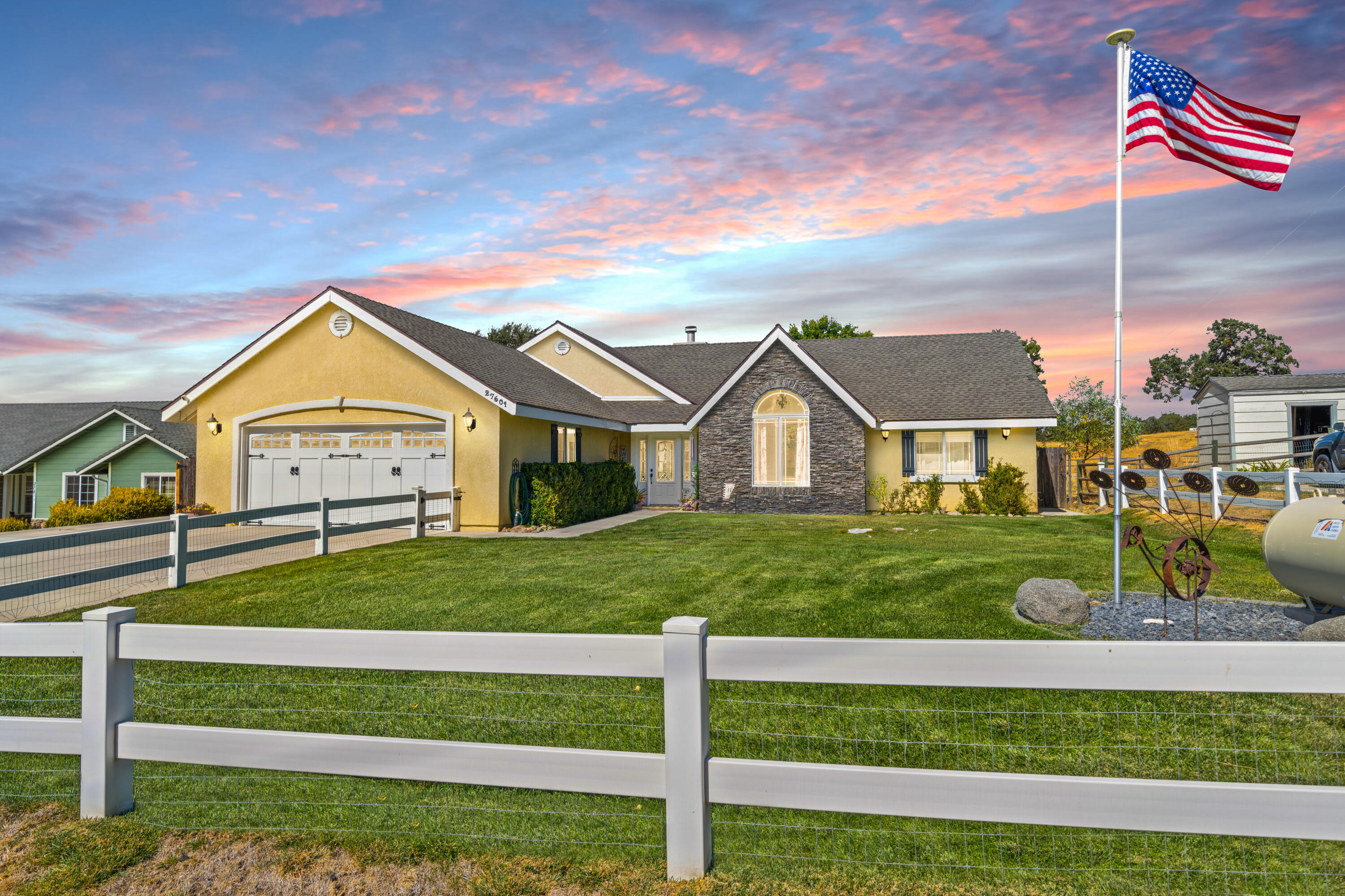 a view of a house with a yard and a garden