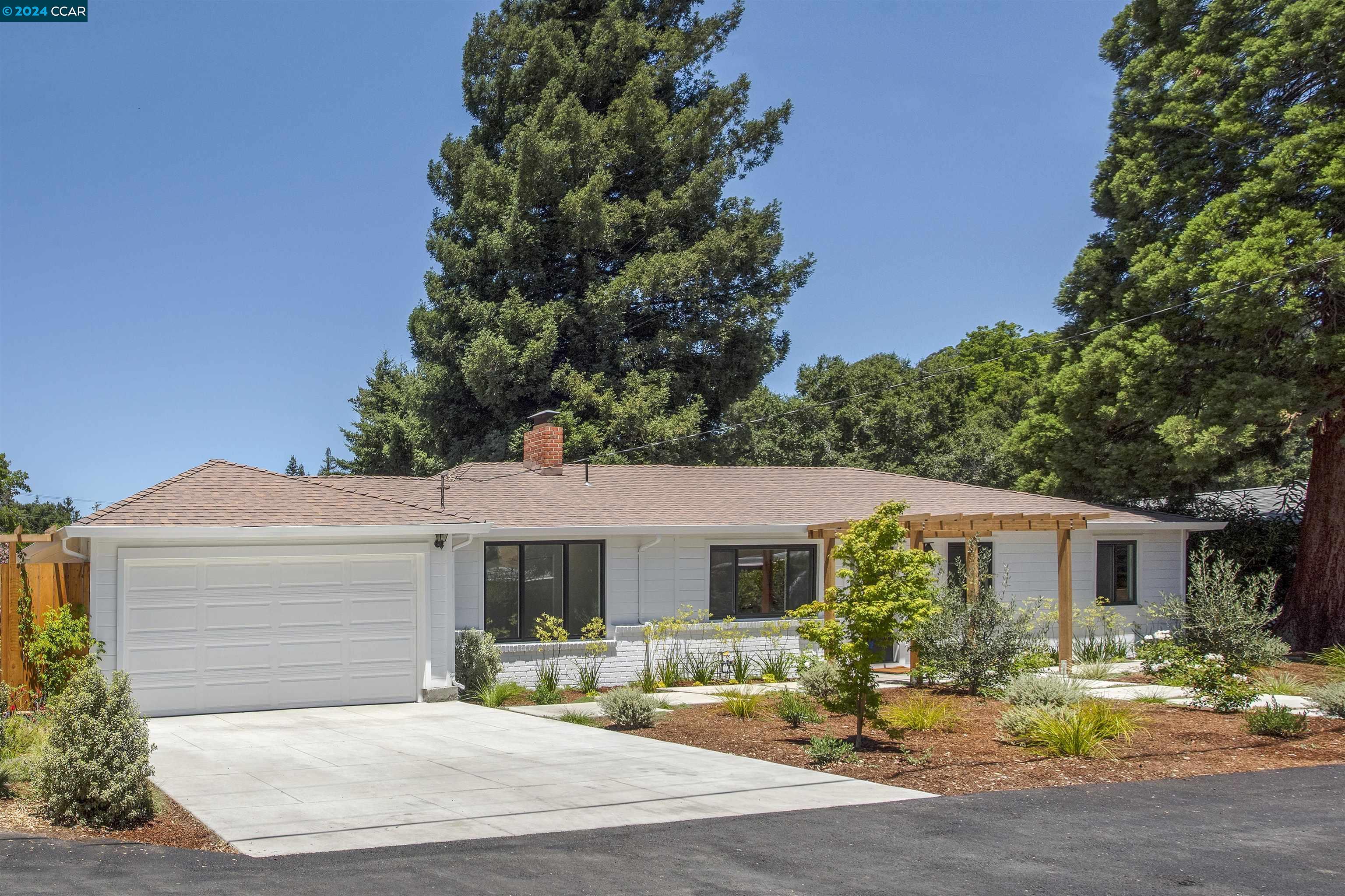 a front view of house with yard outdoor seating and green space