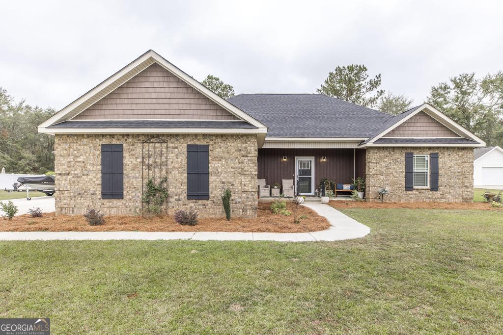 a front view of a house with patio and garden