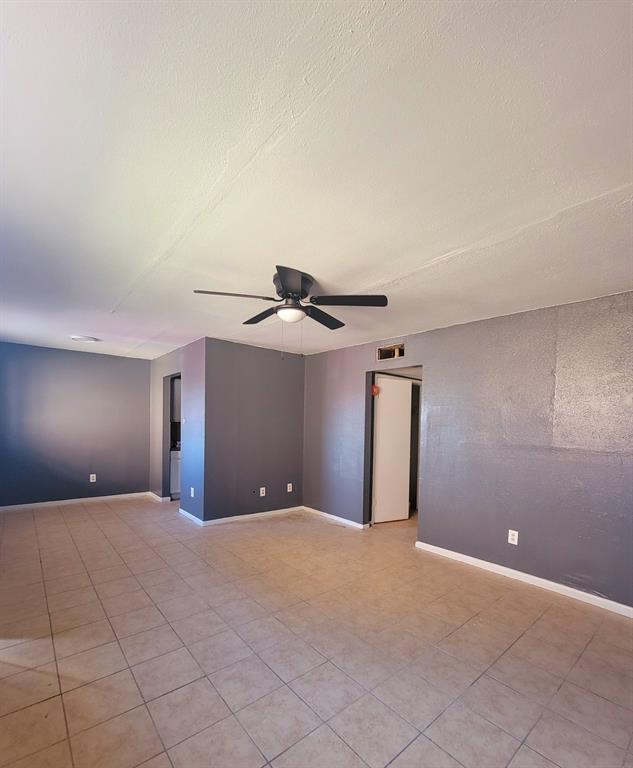 a view of a livingroom with a ceiling fan and window