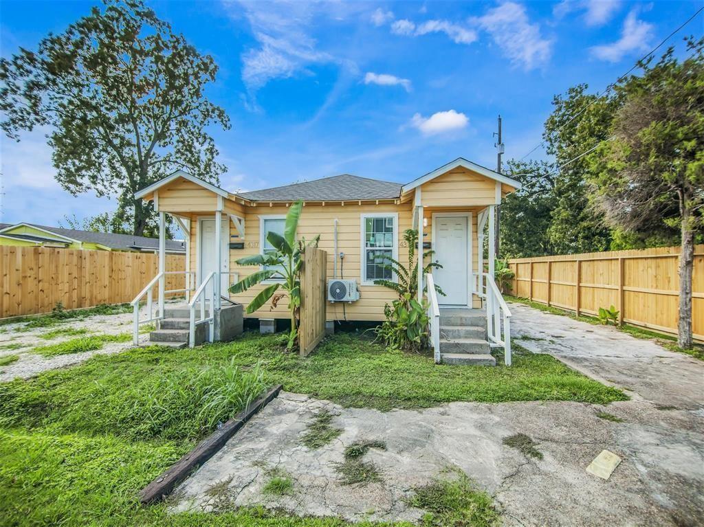 a view of a house with a yard patio and a yard