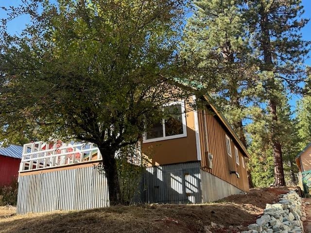 a front view of a house with a tree