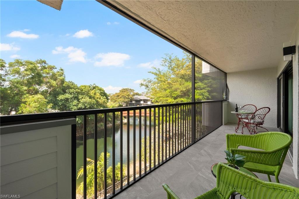 a balcony with table and chairs