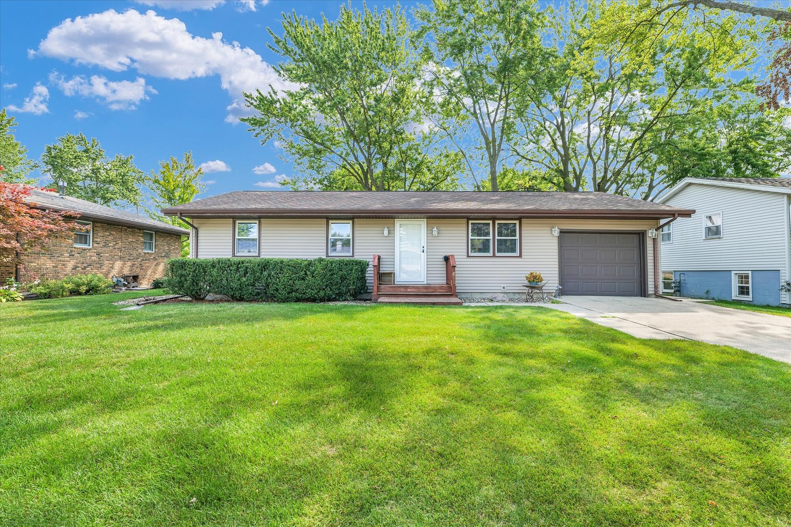 a front view of house with yard and green space