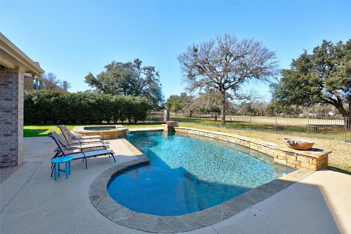 swimming pool view with a seating space