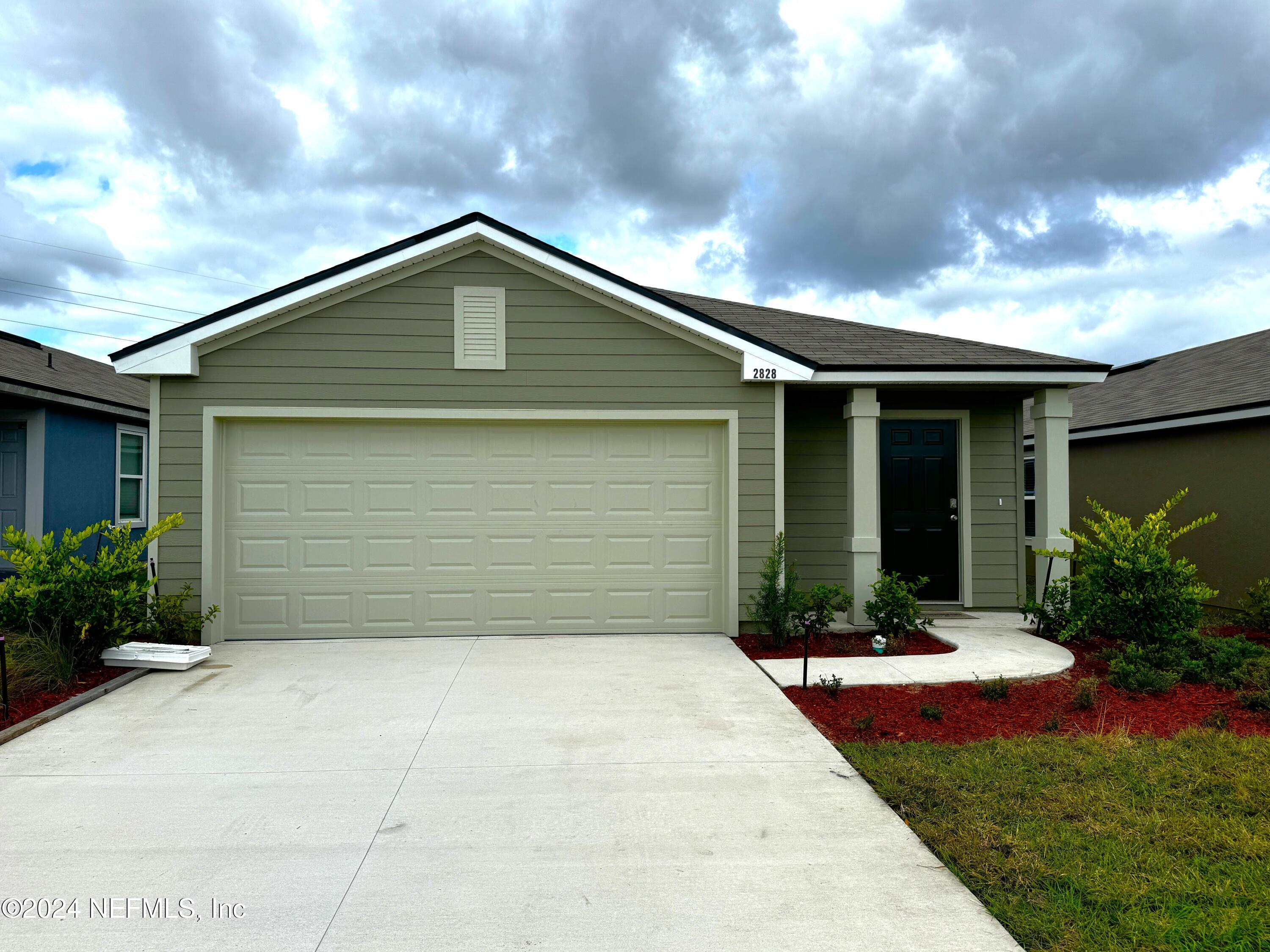 a front view of house with yard and green space