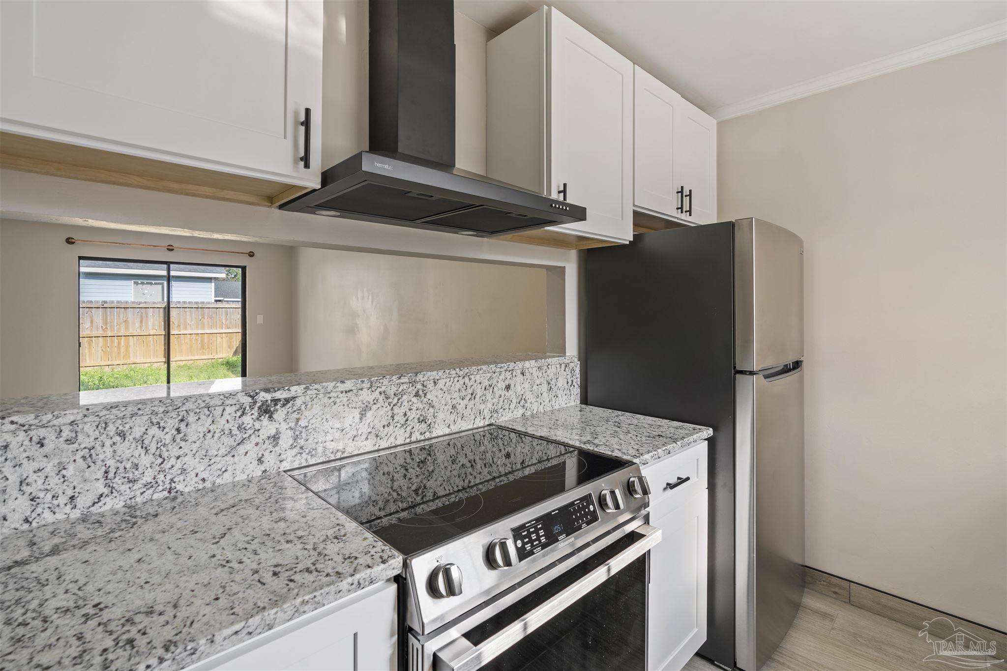 a stove top oven sitting inside of a kitchen