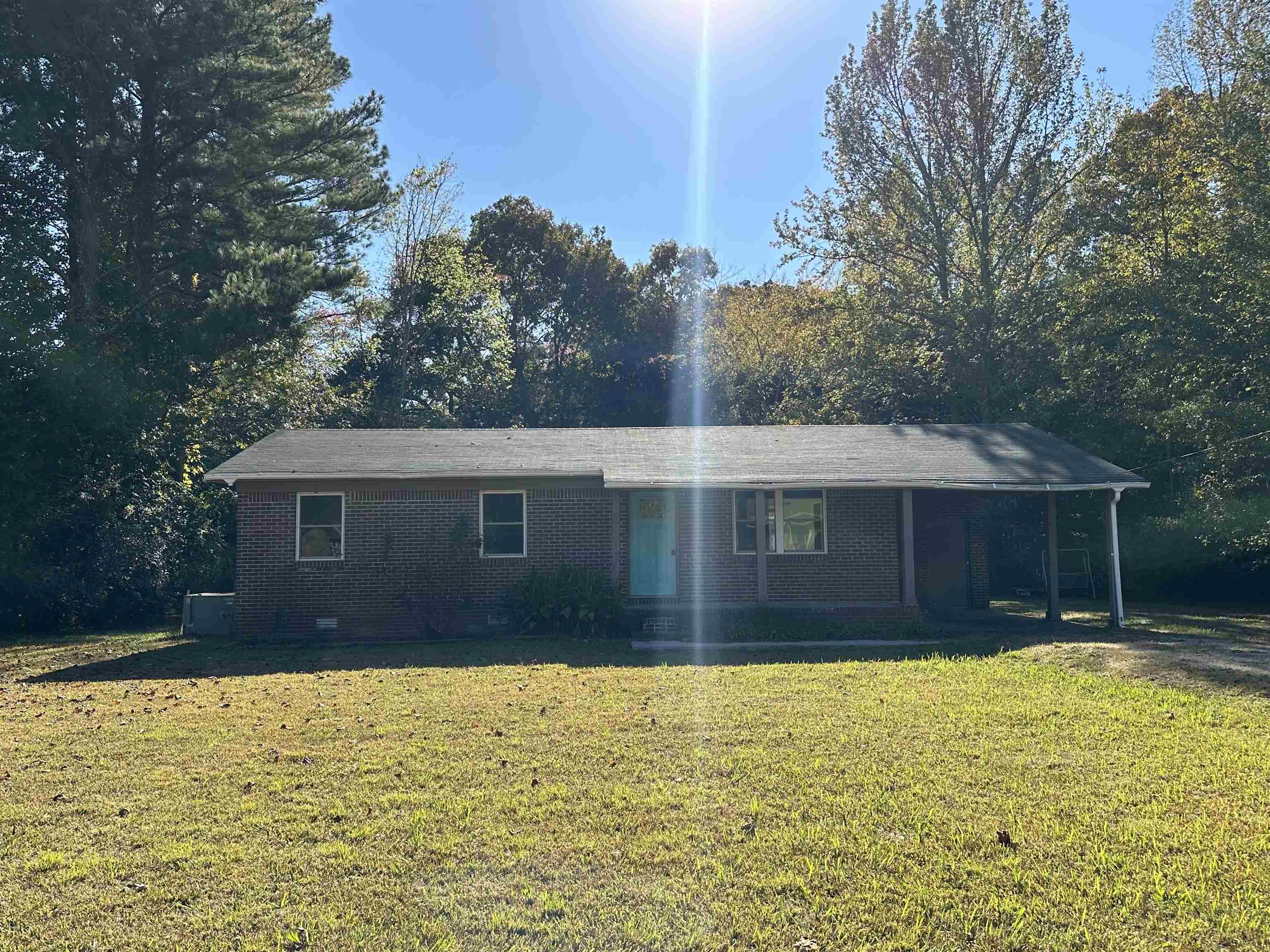 a front view of house with yard and swimming pool