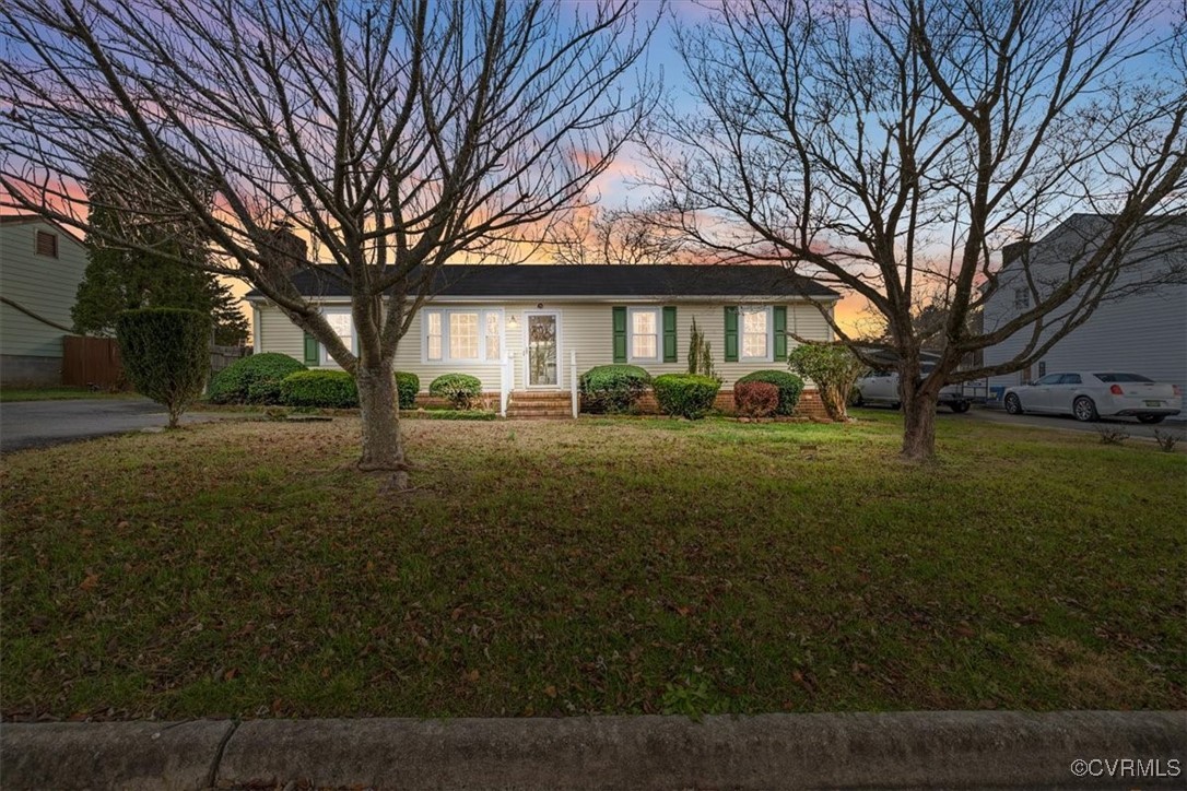 Single story home featuring a yard