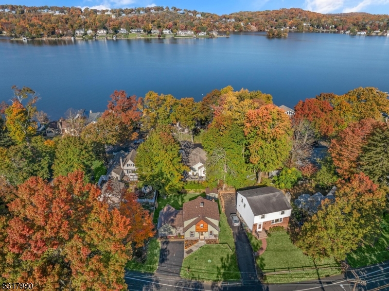 an aerial view of a houses with a lake view