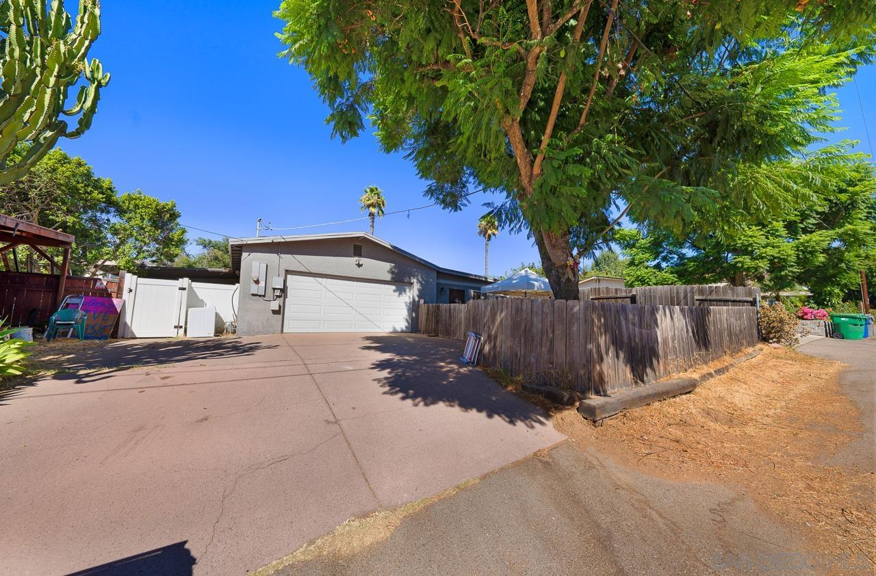 a view of a house with wooden fence next to a road