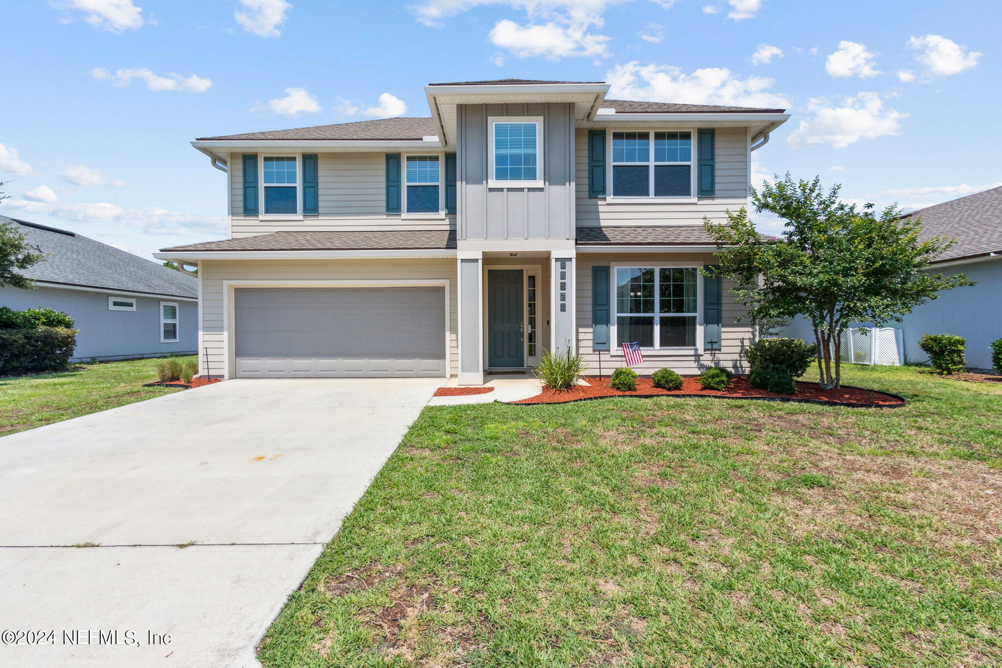 a front view of a house with a yard and garage