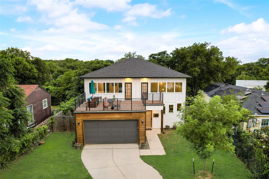 a front view of a house with a garden and yard