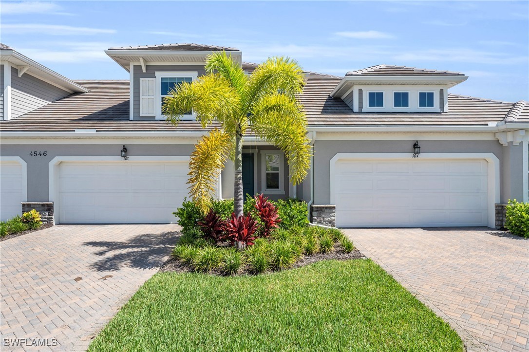 a front view of a house with plants