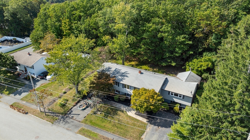 an aerial view of a house with garden space and street view