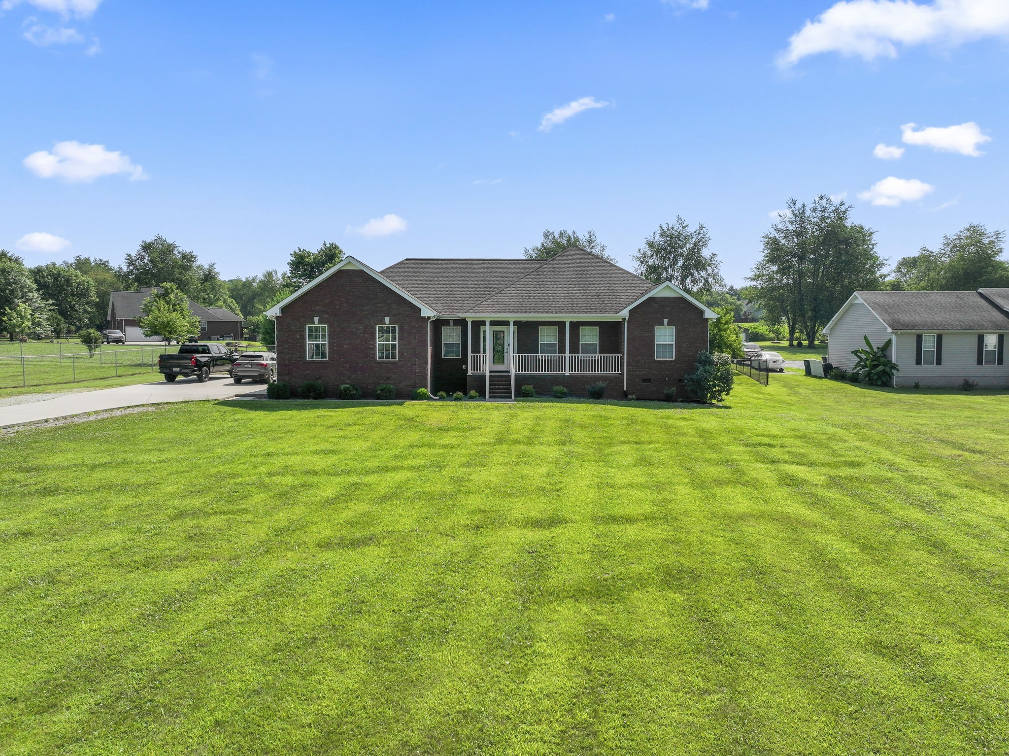 a view of a house with a yard and sitting area