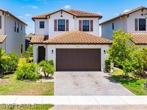 Mediterranean / spanish-style house featuring a garage